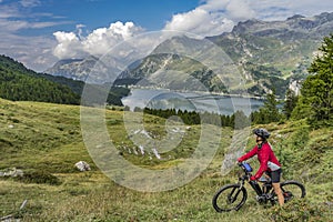 Woman with e mountainbike in the Engadin, Switzerland photo