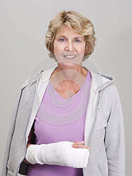 Senior woman with right arm in white cast