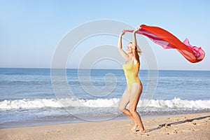 Senior woman running on beach