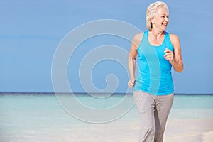 Senior Woman Running On Beautiful Beach