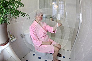 Senior woman running out of toilet paper