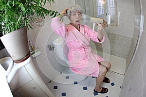 Senior woman running out of toilet paper