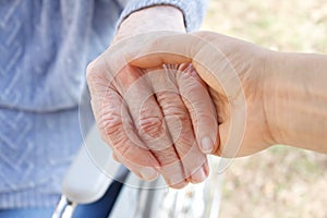 Senior woman's hand and helping hand