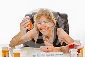 Senior Woman Selects Right Pill Bottle For Her Pill Box