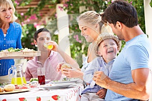 Senior Woman Serving A Family Meal