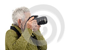 Senior woman shooting with a camera reflex