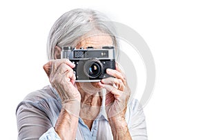 Senior woman shooting with a retro camera.