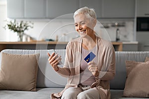 senior woman shopping online making digital payment via smartphone indoor