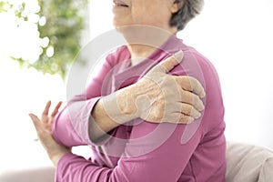 Senior woman shoulder pain osteochondrosis