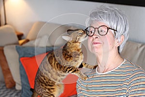 Senior woman showing complicity with her pet photo