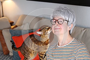 Senior woman showing complicity with her pet