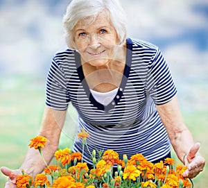 Senior woman showing flowers