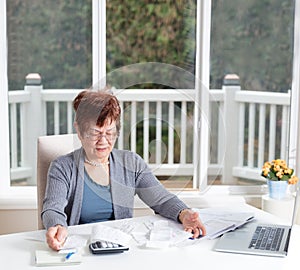 Senior woman showing frustration while working on her financial
