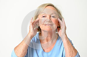 Senior woman showing her face, effect of aging