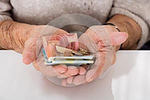 Senior Woman Showing Money On Palm