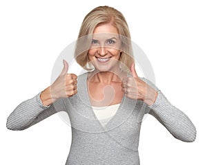 Senior woman showing thumbs up and toothy smiling