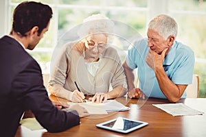 Senior woman signing document