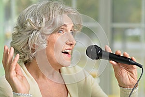 Senior woman singing with microphone