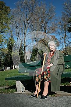 Senior woman sit on a bench