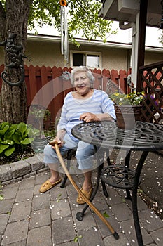 Senior Woman Sitting in Garden