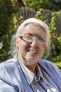 Senior woman sitting in her garden