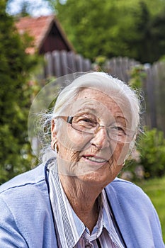 Senior woman sitting in her garden