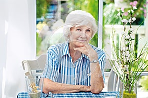 Senior woman sitting at home