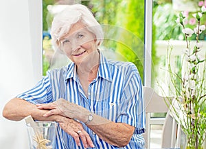 Senior woman sitting at home