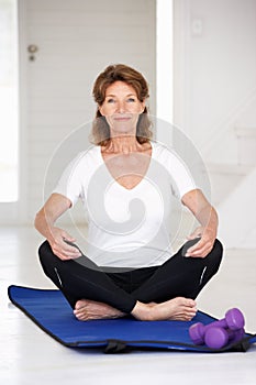 Senior woman sitting in lotus position