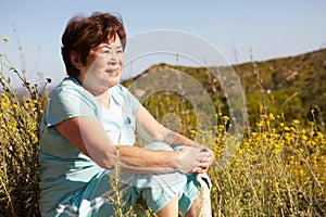 Senior woman sitting outdoors