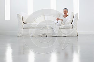 Senior Woman Sitting On Sofa