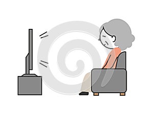 Senior woman sitting on the sofa and watching TV