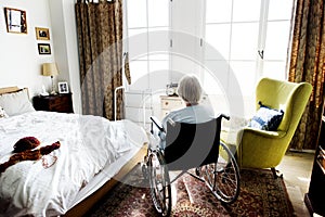 Senior woman sitting on the wheelchair alone