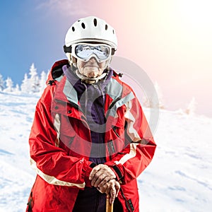 Senior woman in ski jacket and goggles outdoors
