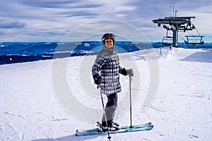 Senior woman skier skiing in the high alpine ski area at Sun Peak