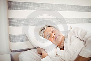 Senior woman sleeping on bed