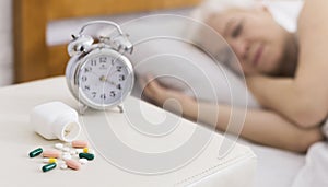 Senior woman sleeping in bed with help of pills