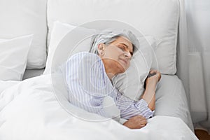 senior woman sleeping in bed at home bedroom