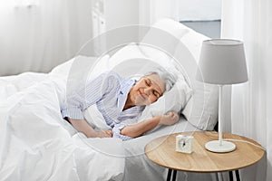 senior woman sleeping in bed at home bedroom