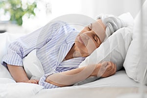 senior woman sleeping in bed at home bedroom