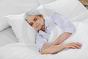 senior woman sleeping in bed at home bedroom