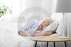 senior woman sleeping in bed at home bedroom