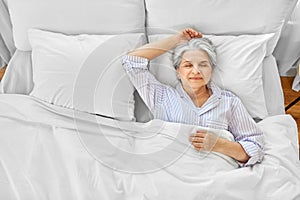 senior woman sleeping in bed at home bedroom