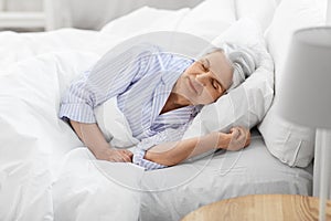 senior woman sleeping in bed at home bedroom