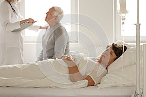 Senior woman sleeping in hospital bed