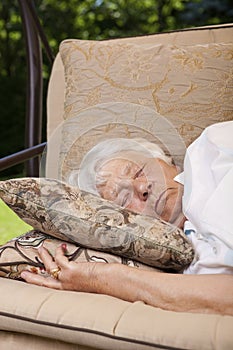 Senior woman sleeping outside