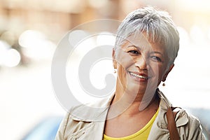 Senior woman, smile and portrait in outdoor for style and relax for retired and elderly in urban or city. Pensioner or