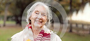 Senior woman with a smile, portrait in the park and happiness in nature, woods or outdoor for a walk in retirement