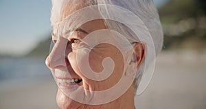 Senior woman, smile and sunset at a beach with peace outdoor in nature, sea and elderly female person with mindfulness