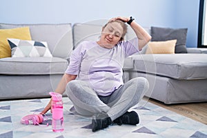 Senior woman smiling confident stretching neck at home